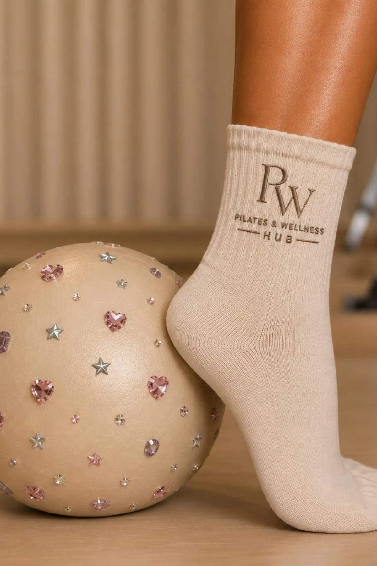 PW Pilates sock beside a Pilates ball